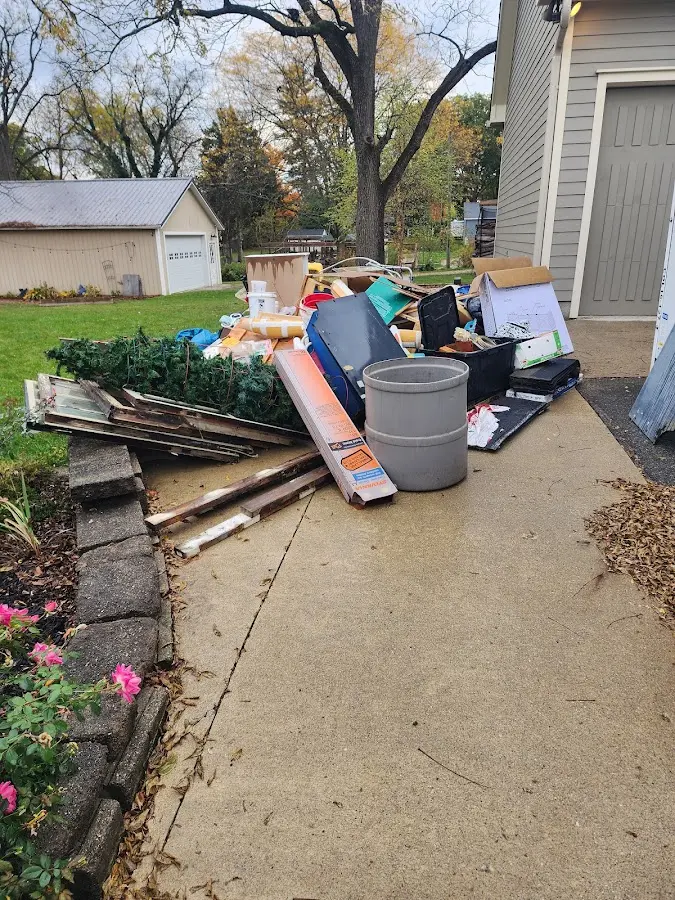 Dumpster being loaded with debris for Estate Cleanout Dumpster Rental in Millstadt